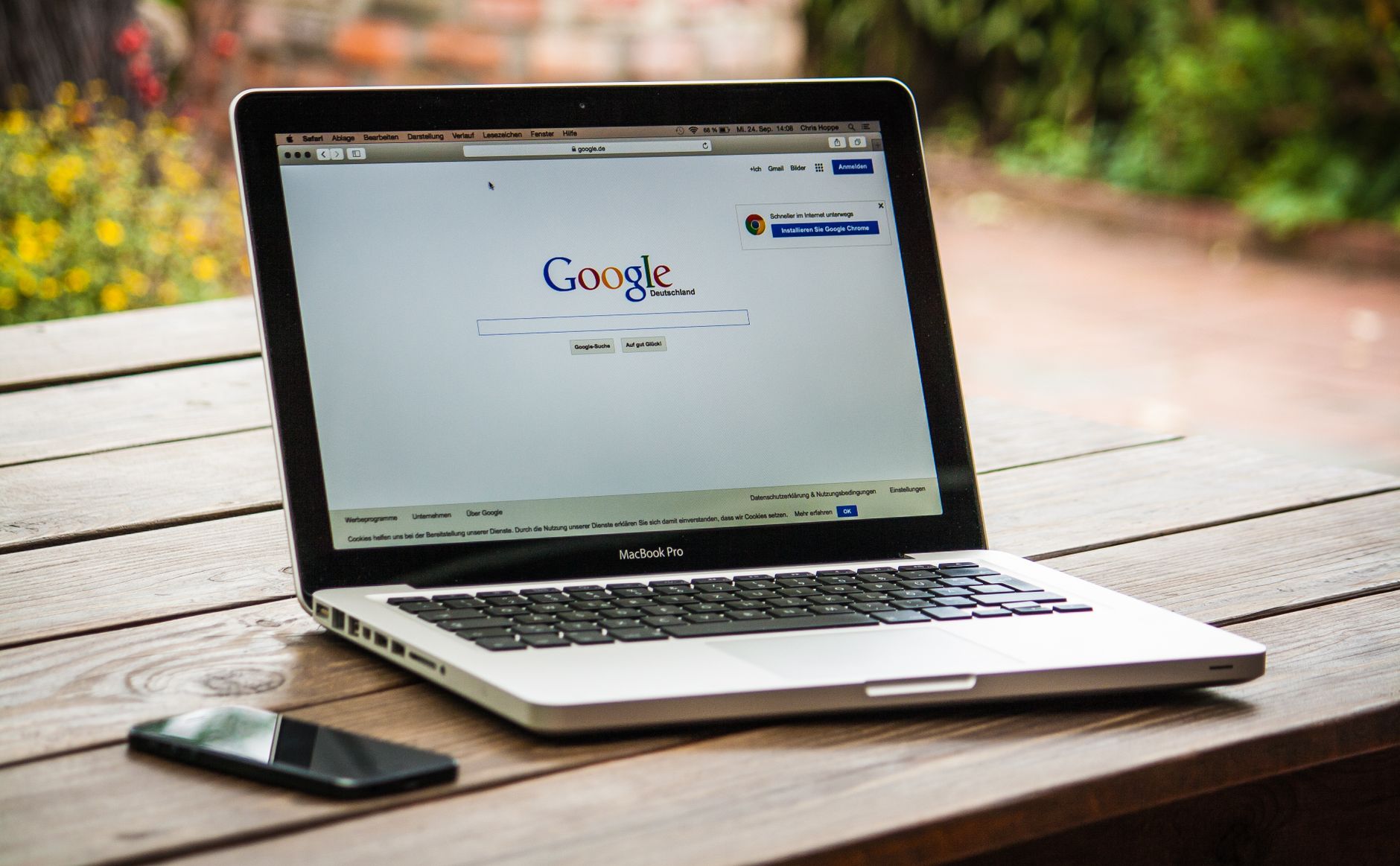 MacBook Pro displaying Google Search on a wooden table, representing WordPress SEO setup for beginners. Photo by Pexels.