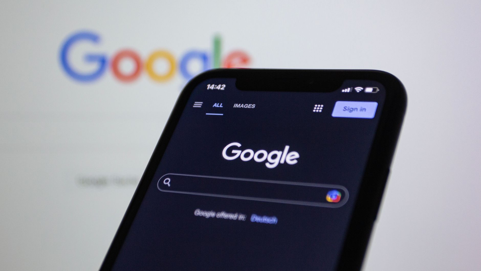 Smartphone displaying Google search in dark mode — representing search engine crawlability and indexing