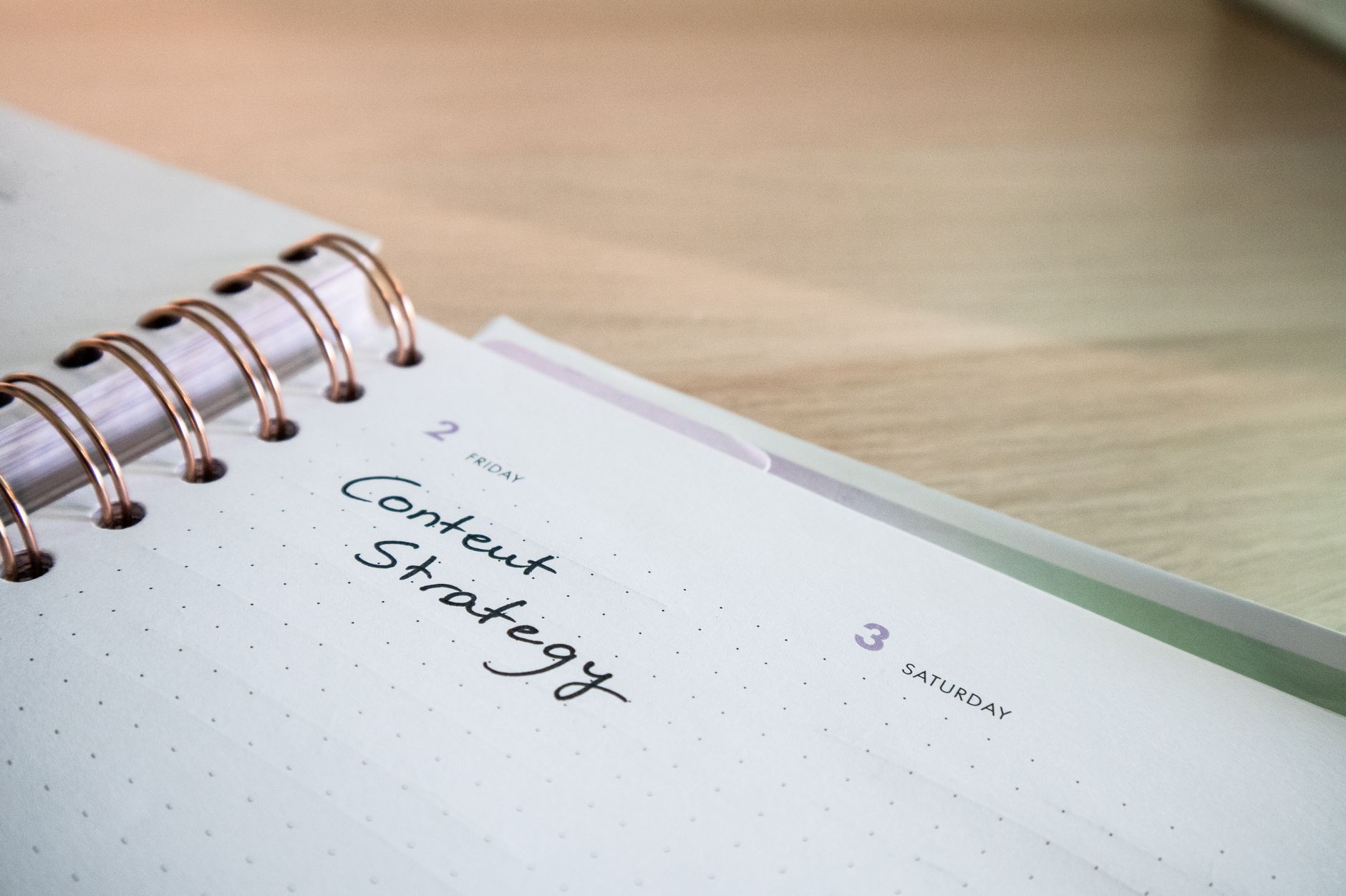 Notebook open to a page with Content Strategy written by hand — focusing on helpful content for WordPress SEO beginners