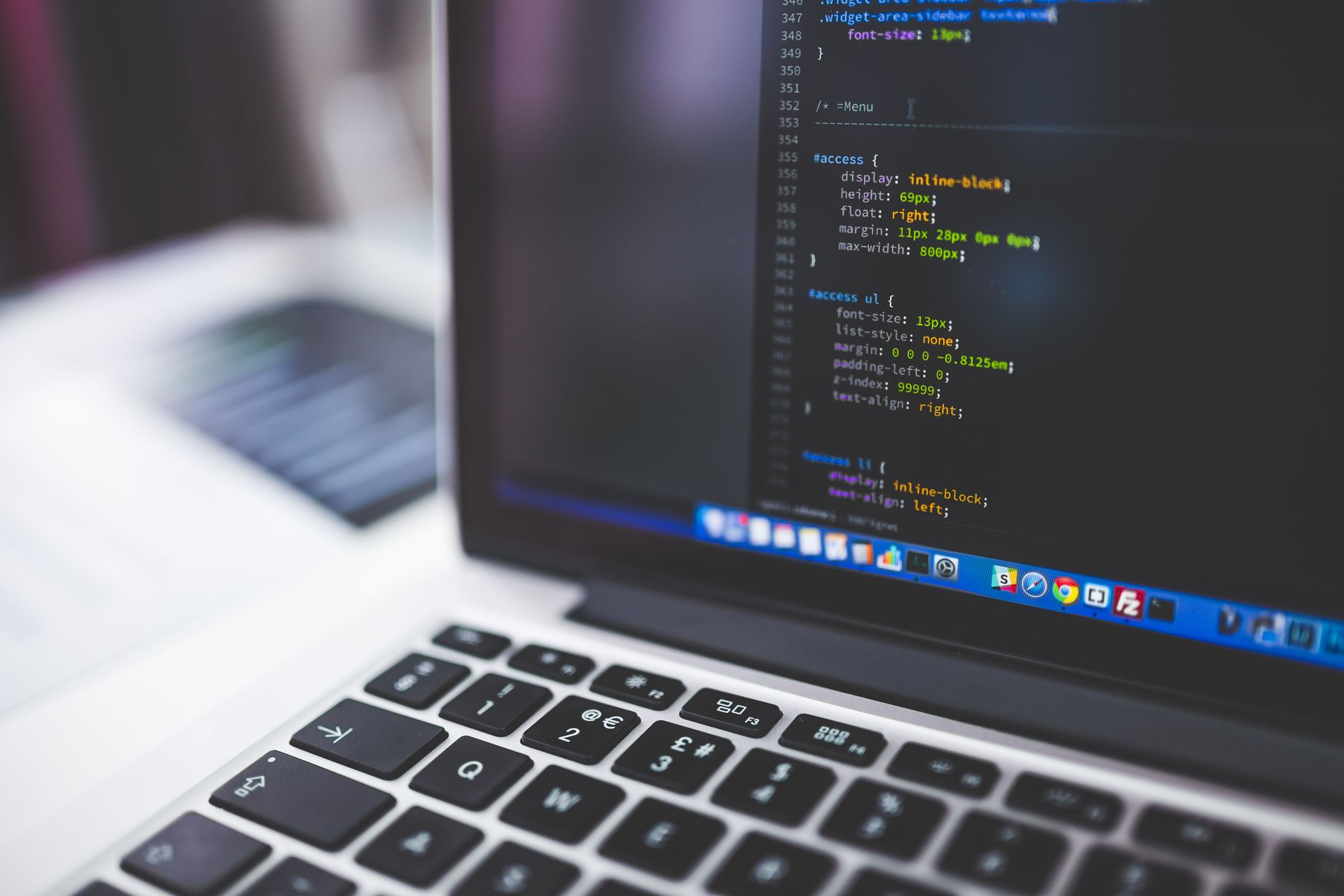 Laptop screen displaying CSS and HTML code representing technical SEO and website development