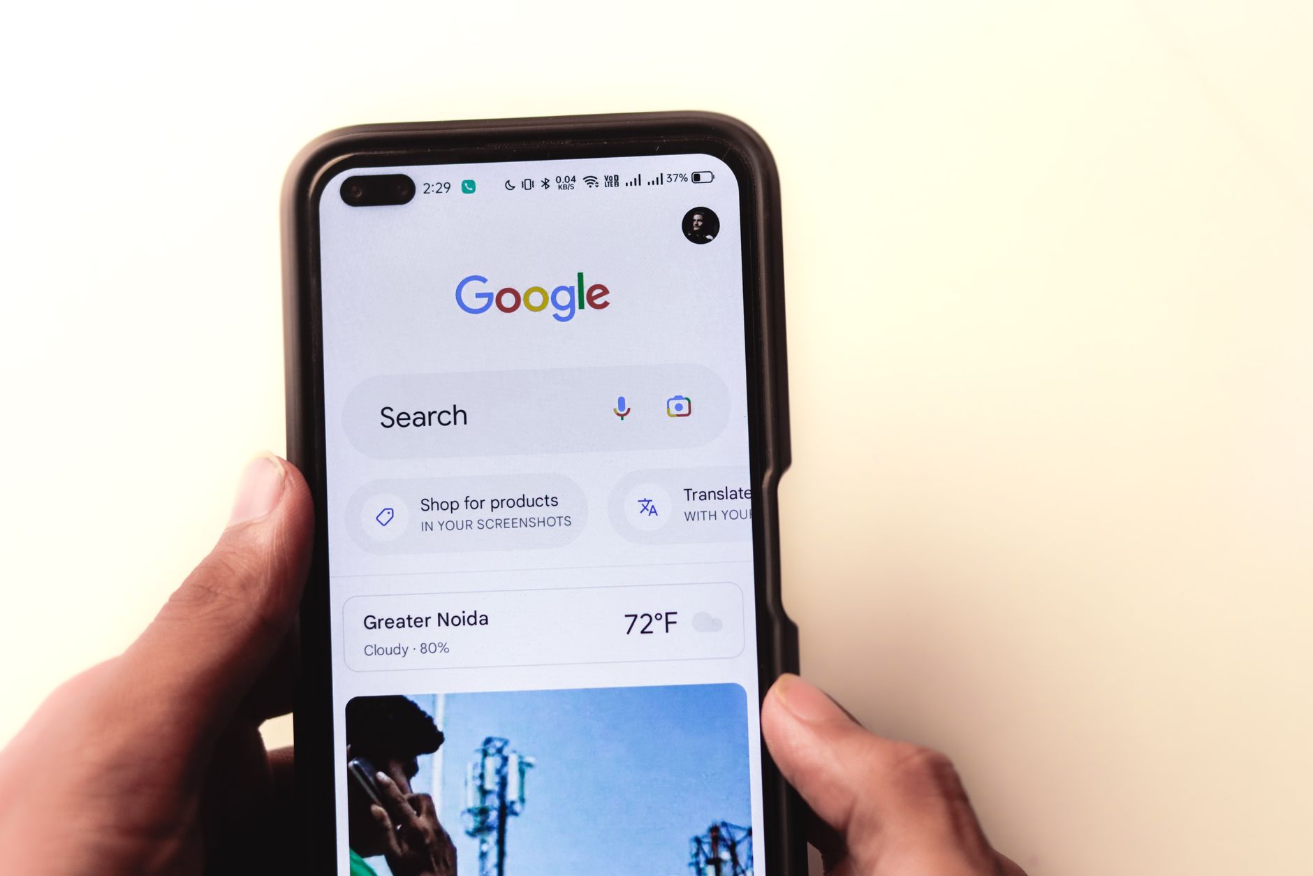 Hand holding a smartphone with Google Search displayed on the screen, representing mobile SEO optimization