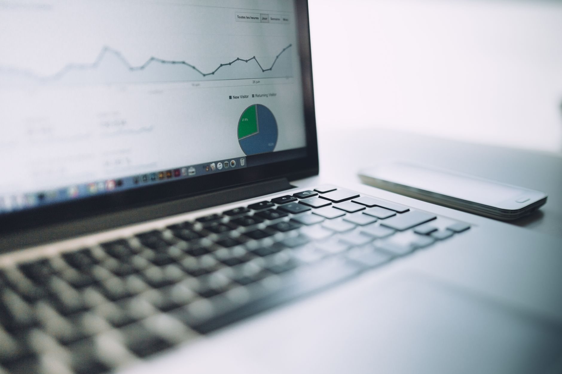 Laptop displaying an analytics dashboard with charts and graphs representing WordPress SEO performance tracking