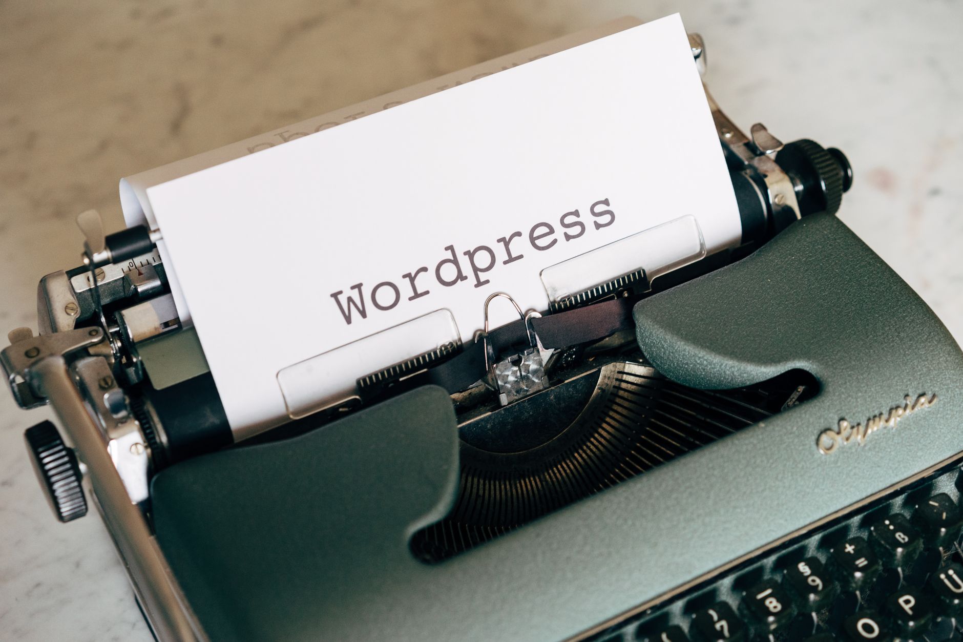 Vintage typewriter with a page reading WordPress, representing WordPress plugin configuration and setup
