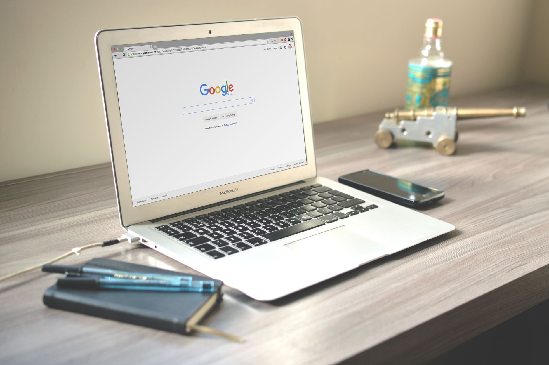 Laptop on a wooden desk displaying the Google search homepage, representing WordPress Google SEO strategy for local businesses