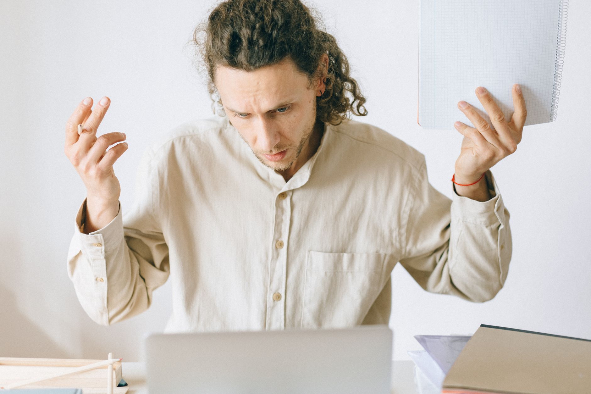 Frustrated man at desk with laptop showing confusion from bad SEO tutorial advice