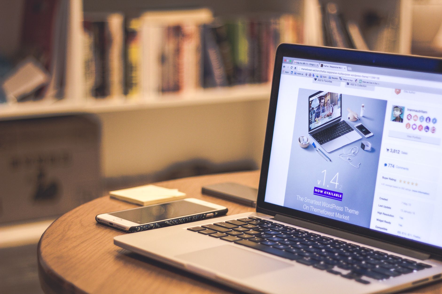 Laptop showing a WordPress website on screen, placed on a desk next to a smartphone in a cosy home workspace — representing WordPress beginner SEO setup.