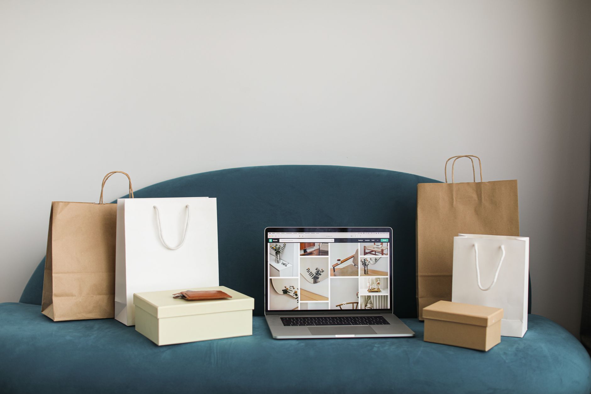 Laptop displaying an ecommerce website surrounded by shopping bags and boxes, representing WordPress ecommerce SEO strategy