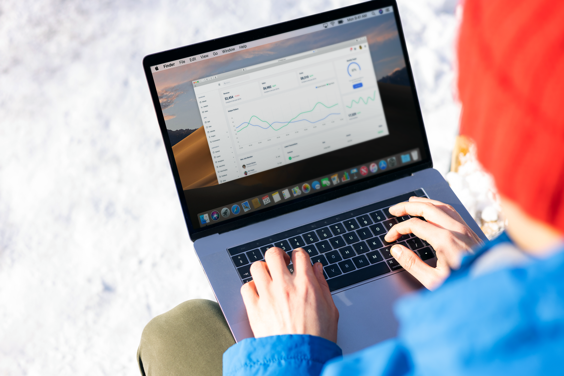 Person analyzing website performance data and analytics charts on a laptop, representing technical SEO monitoring
