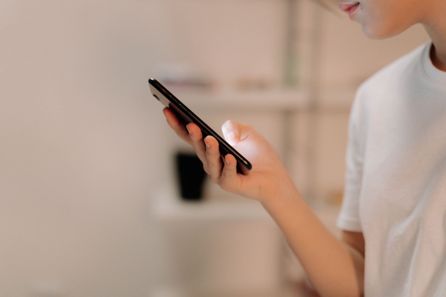 Person in a white shirt using a smartphone, illustrating a clean and readable mobile layout experience