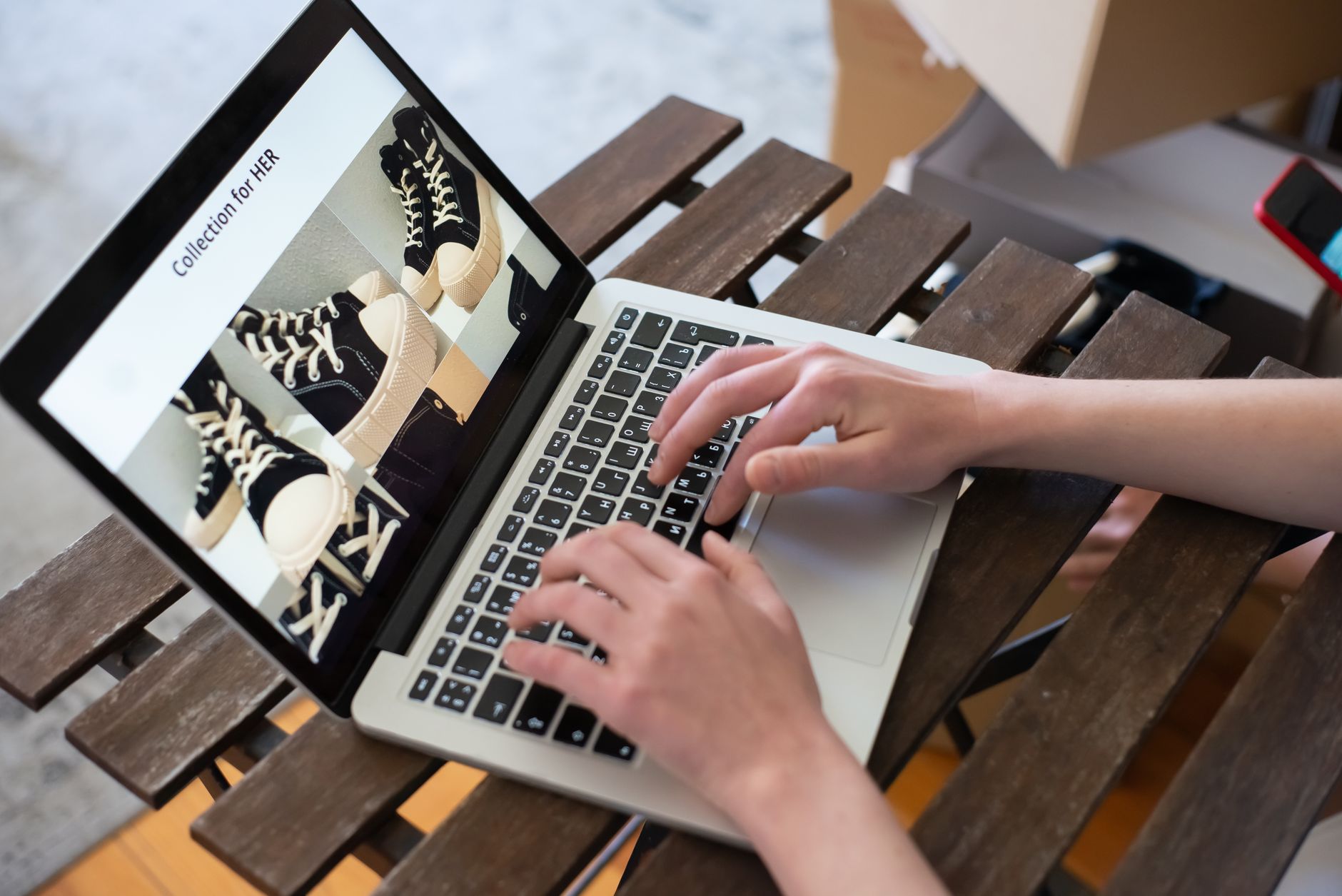 Person browsing a product collection page on a laptop, representing ecommerce product page optimization