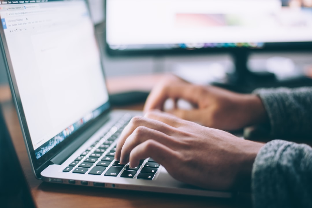 Person typing on a laptop, writing and editing website title tags for WordPress SEO