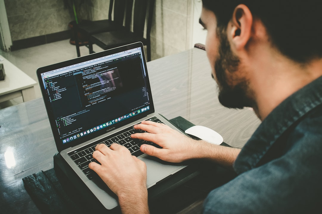 Web developer reviewing WordPress site code on a laptop to improve SEO fundamentals