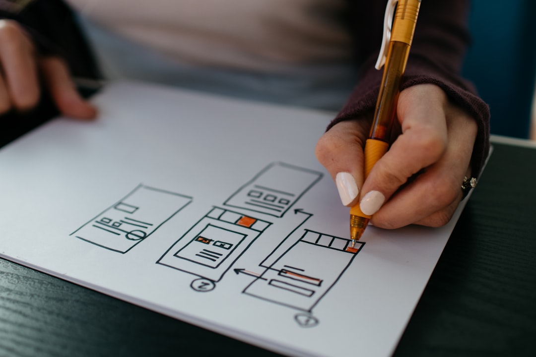 Hand sketching a website structure wireframe — planning internal linking architecture for SEO