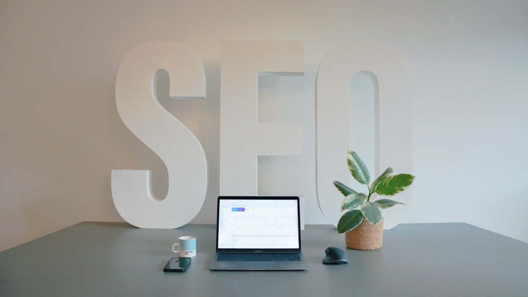 SEO workspace with laptop and large SEO letters representing title tag and keyword strategy